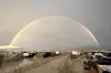 The undated image shows a rainbow seen over the muddy grounds of the 'Burning Man' festival.