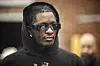 Young thug wearing his hood up and dark sunglasses
