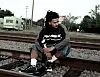 J cole sitting on train tracks