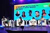 Panelists seated on stage discuss earning money from digital music streaming services.