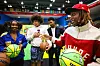 Lil Durk interacts with students holding STARRY basketballs on a court at Jackson State University.