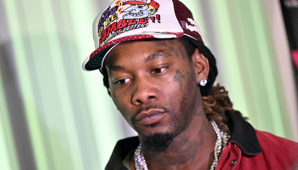 Offset wearing a colorful trucker hat and red jacket at a charity event in Georgia