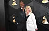 Terry Crews and wife Rebecca smile on the Grammy Awards red carpet in Los Angeles.