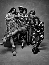 Group of models in patterned streetwear posing together in a studio portrait
