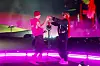Justin Bieber and Sexyy Red perform together on a neon-lit Coachella stage.
