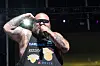 Action Bronson raps onstage at BottleRock 2024 wearing a New York Knicks tank top and sunglasses.
