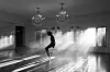 Jaafar Jackson as Michael Jackson dancing in a bright room with chandeliers and strong window light