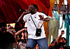Isaiah Rashad raps on the Do LaB stage at Coachella 2026 with fans cheering around him.