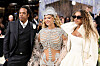 Jay-Z, Beyoncé and Blue Ivy Carter posing together at the Met Gala in ornate formalwear.