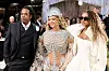 Jay-Z, Beyoncé and Blue Ivy Carter posing together at the Met Gala in ornate formalwear.