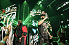 Rick Ross and French Montana performing onstage under green lights during a VERZUZ event.
