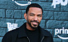 Laz Alonso poses in front of a branded The Boys backdrop at an event in Los Angeles.