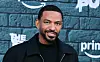Laz Alonso poses in front of a branded The Boys backdrop at an event in Los Angeles.
