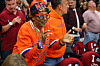 Spike Lee wearing Knicks colors sits courtside and claps during an NBA playoff game.