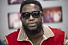 Gucci Mane wearing sunglasses and a red jacket during a meet and greet at DBS Sounds.