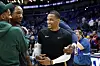 Russell Westbrook stands courtside smiling with people around him after a game in New Orleans.