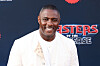 Idris Elba smiles at the 'Masters of the Universe' world premiere in front of a promotional backdrop.
