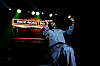 Rick Ross performs onstage beside a piano under bright stage lights at James L. Knight Center.