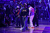 Wu-Tang Clan members perform on the basketball court under purple lighting at Madison Square Garden.