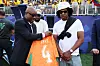 Yacine Idriss Diallo presents an orange shirt marked Jay-Z to Jay-Z before a World Cup match.