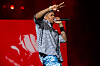 Rapper YG performs onstage in front of a red backdrop at Rolling Loud Los Angeles 2023.