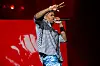 Rapper YG performs onstage in front of a red backdrop at Rolling Loud Los Angeles 2023.
