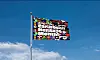 A multicolored Caribbean Heritage Month flag flying on a pole against a blue sky.