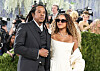 Jay-Z and Blue Ivy Carter stand together at the Met Gala in formal attire.
