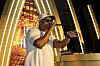 Lupe Fiasco performs onstage wearing sunglasses and a cap at a Derby day after party.