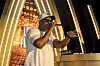 Lupe Fiasco performs onstage wearing sunglasses and a cap at a Derby day after party.