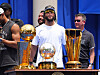 New York Knicks championship trophies displayed on a stage with people standing behind them outside City Hall.