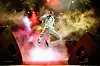 Tyler, The Creator jumps above the stage amid colorful smoke, lights, and speakers at Camp Flog Gnaw.