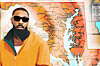 Bearded man in sunglasses and an orange jacket standing before a map of Maryland and the Chesapeake Bay.