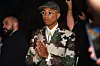 Pharrell Williams in green and brown suit