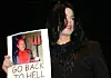 Singer Michael Jackson holds a picture of Sony chairman, Tommy Mottola, during the '30 Years of Magic' fan celebration by the Michael Jackson Fan Club on July 6, 2002 at Webster Hall in New York City.