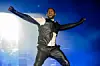 Usher performing, looking happy