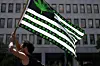 A cannabis activist holds a flag during a march on Independence Day on July 4, 2021 in Washington, DC.