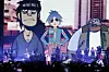 Damon Albarn on stage in front of animated band Gorillaz