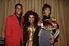Singer Babyface in a red suit with singers Chaka and Whitney Houston wearing gowns