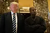 Donald Trump and Kanye West stand together in the lobby at Trump Tower,