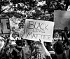 A woman holds a sign for BLM during a protest in Washington, DC