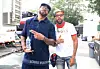 Method Man and Redman wearing street clothes posing for a photo backstage and outside in the sun.