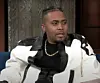 Nas on Stephen Colbert with black and white jacket