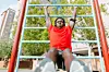 Man doing exercises on outdoor machine - stock photo.