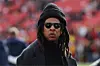 Jay-Z (C) looks on before a game between the Washington Commanders and the Dallas Cowboys at Northwest Stadium on November 24, 2024 in Landover, Maryland.