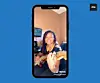 A girl on a phone plays guitar.