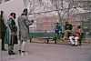 Man directing people on park bench