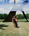 Couple standing in front of statue