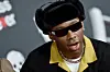 Tyler, the Creator wearing sunglasses and a hat