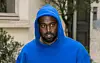 Kanye is seen walking in Paris in a royal blue hoodie in March of 2020.